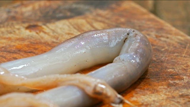 Fresh Tamilok on a wooden cutting board