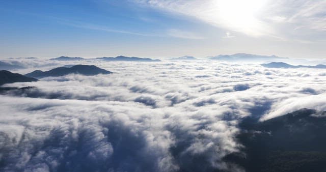 Clouds covering mountains and buildings