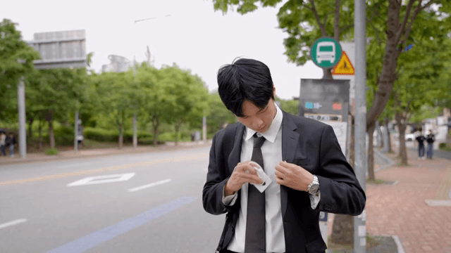 Anxious office worker waiting for a bus at a bus stop