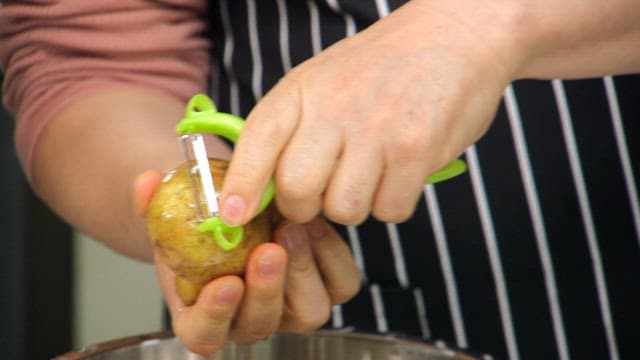 Peeling a potato with a peeler