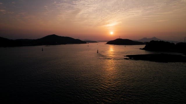 고요한 해안 풍경 위로 지는 태양