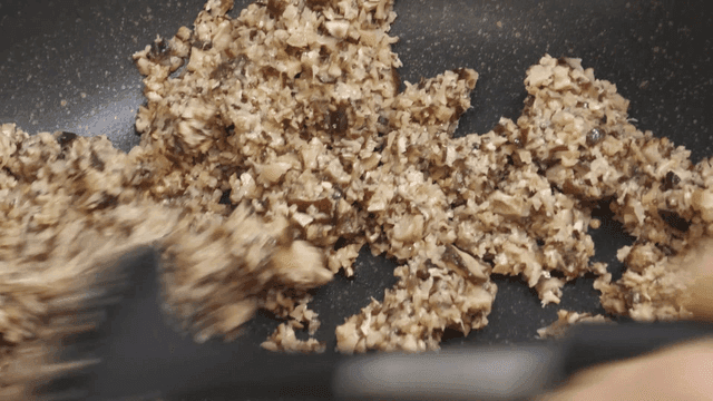 Minced shiitake mushrooms stir-fried in frying pan