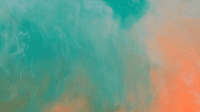 초록색과 주황색 액체가 혼합되는 추상적인 패턴