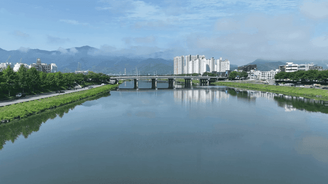 River with apartments and mountains in view