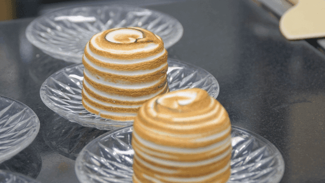 Toasted meringue desserts on glass plates