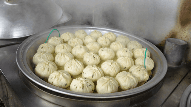 Steamed dumplings being cooked in a kitchen