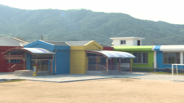 Colorful elementary school building with mountain in background
