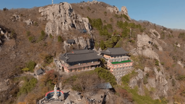 Temple nestled in a rocky mountain landscape