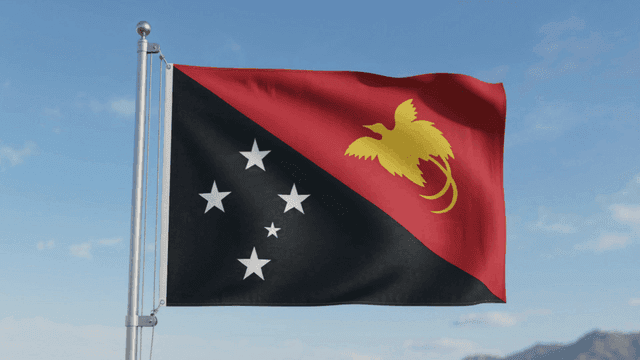 Papua New Guinea flag fluttering under clear sky