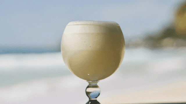 Creamy cocktails on beach table