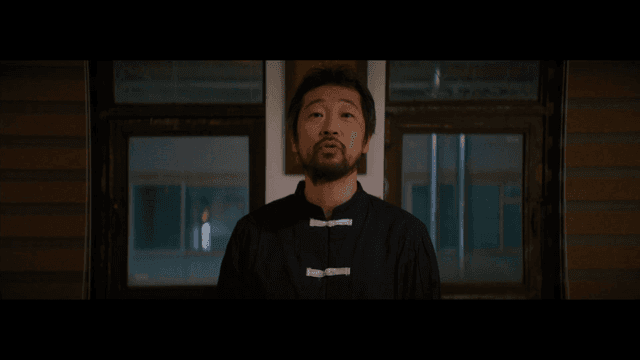 Man standing calmly in traditional Chinese clothing