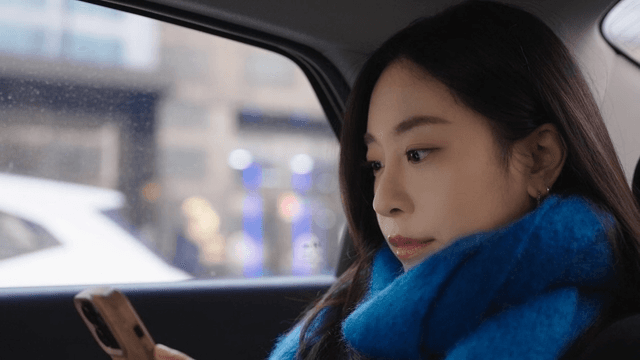 Woman looking at her phone in a taxi