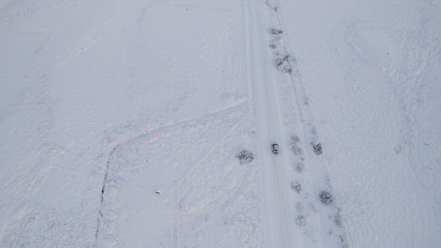 Car driving through a snowy landscape