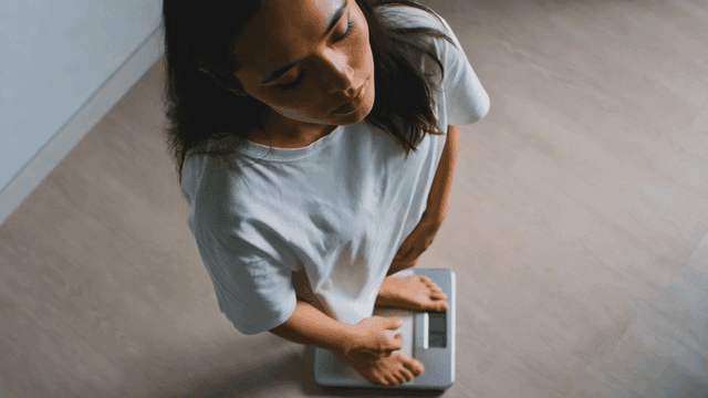 Woman standing on scale