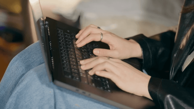 Person typing on a laptop indoors