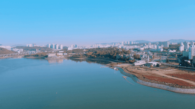 A cityscape with a river and buildings