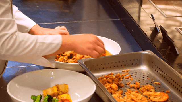 Chef preparing a seafood dish in the kitchen