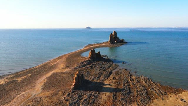 Serene seaside rock formations under the sun