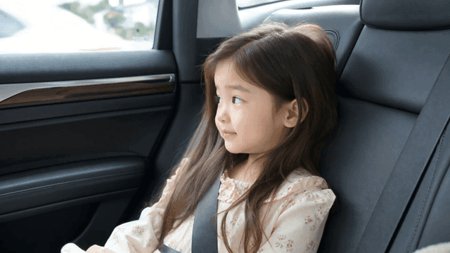 Girl smiling in car