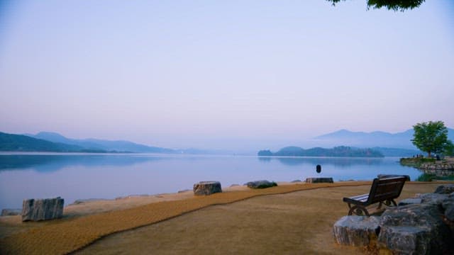 Serene Lakeside Dawn with Mountains