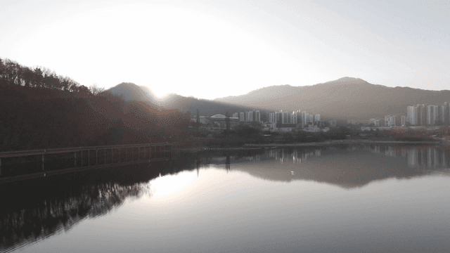 Tranquil lake reflecting sunrise