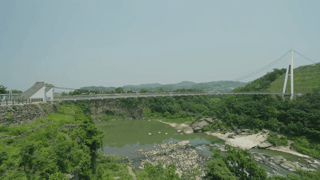 Suspension bridge over scenic river