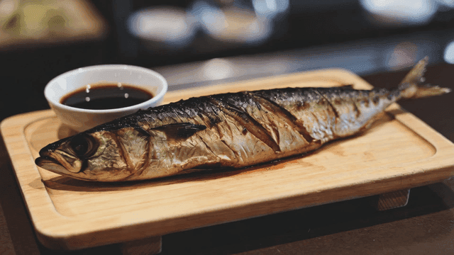 Grilled mackerel on a wooden board
