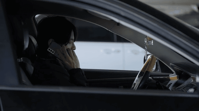 Man sitting in a car making a phone call