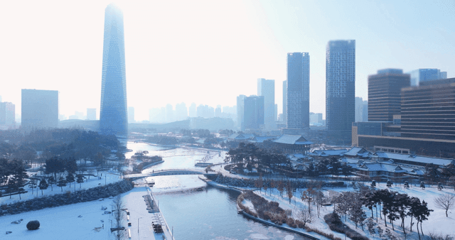 Snow-covered cityscape with tall buildings