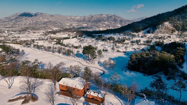 Snowy Landscape with Mountainous Backdrop