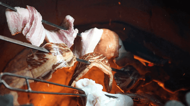 Meat skewers roasting over an open flame