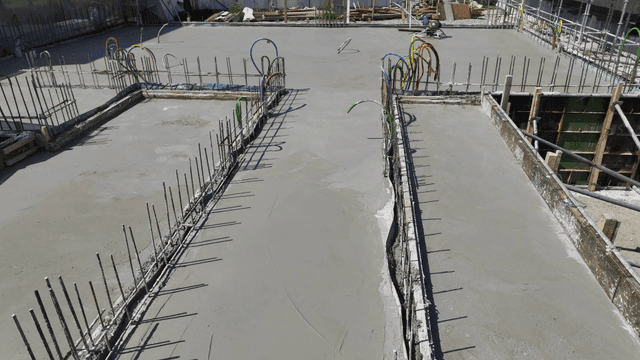 Concrete foundation with pipes and rebar