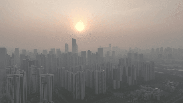 Sunset over a hazy city skyline