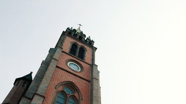 A tall historical cathedral tower under clear sky