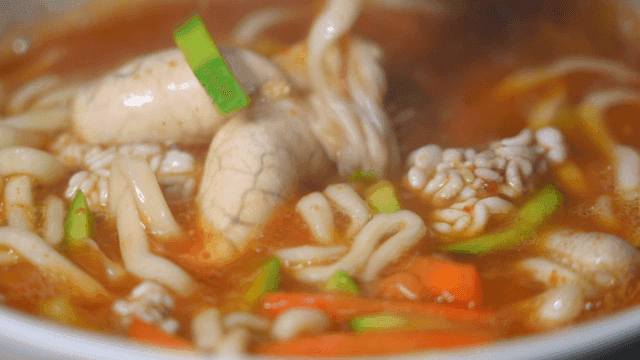 Spicy seafood kalguksu with vegetables and fish roe