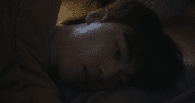 Person lying in bed at night