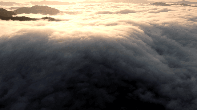 Sea of ​​clouds above mountain peaks