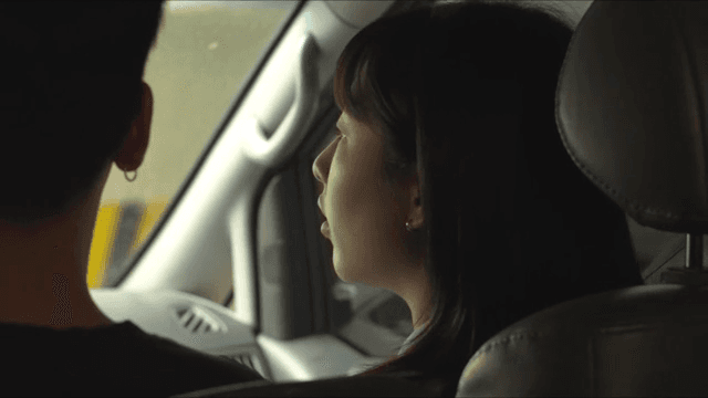 Woman sitting in car and talking