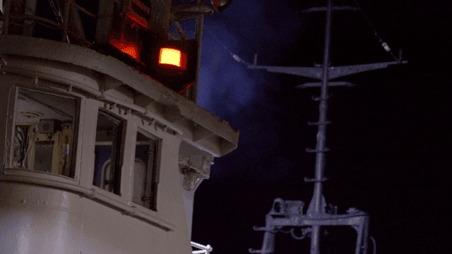 Ship's wheelhouse with lights at night