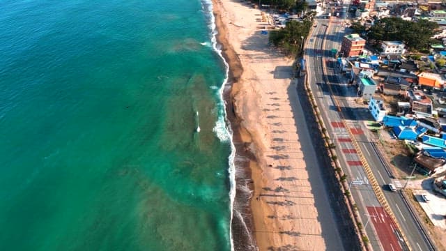 Coastal road beside a serene beach