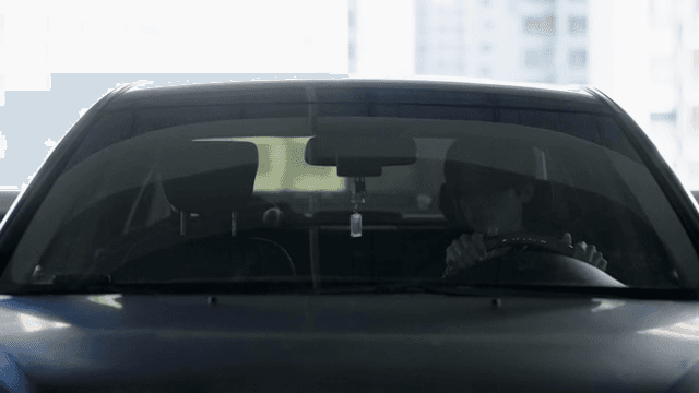 Person driving a car in a parking lot