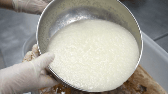 Mixing ingredients in a large container