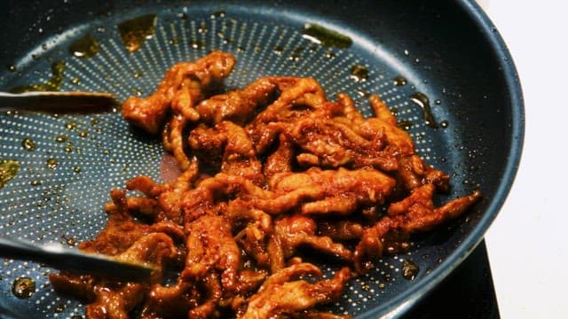 Stir-Fried Chicken Feet Cooking in a Frying Pan