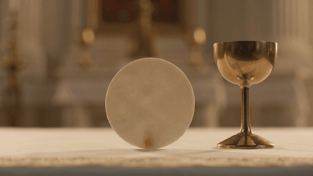 Chalice and host on an altar