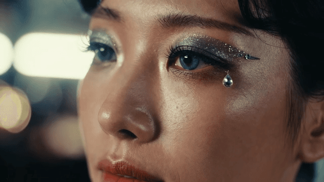 Close-up of a woman's eye with glitter makeup