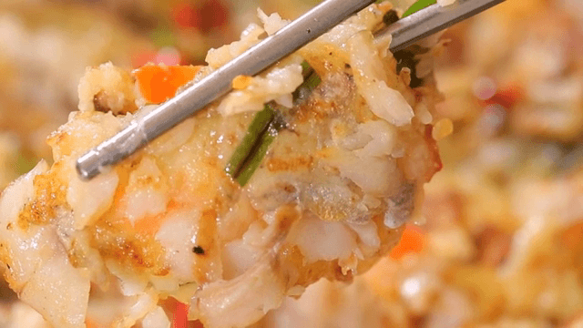 Pan-fried battered pollack picked up with chopsticks