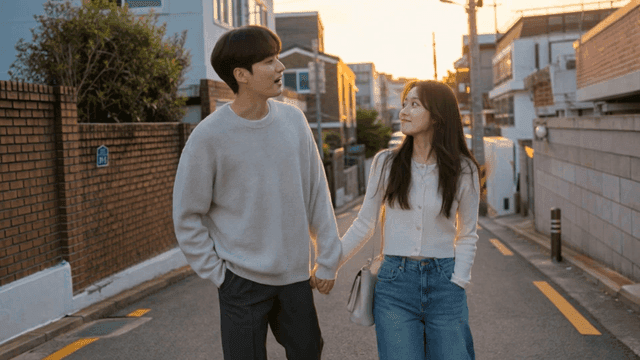 Couple walking hand in hand at sunset