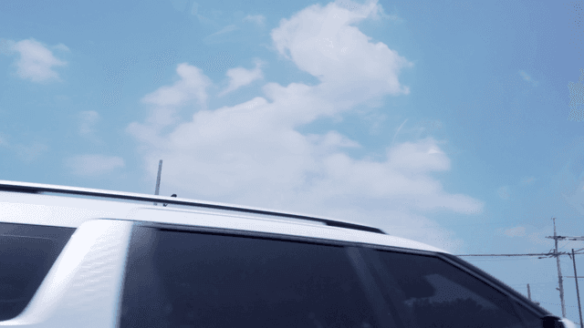 Clear sky with scattered clouds and trees