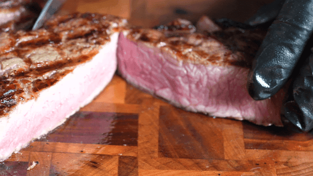 Juicy steak sliced ​​on cutting board