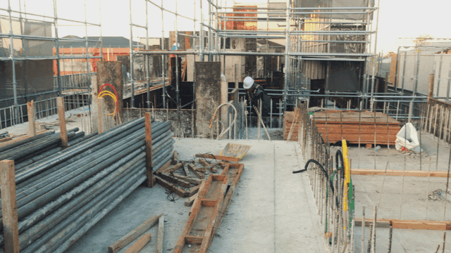 Construction site with steel materials and workers